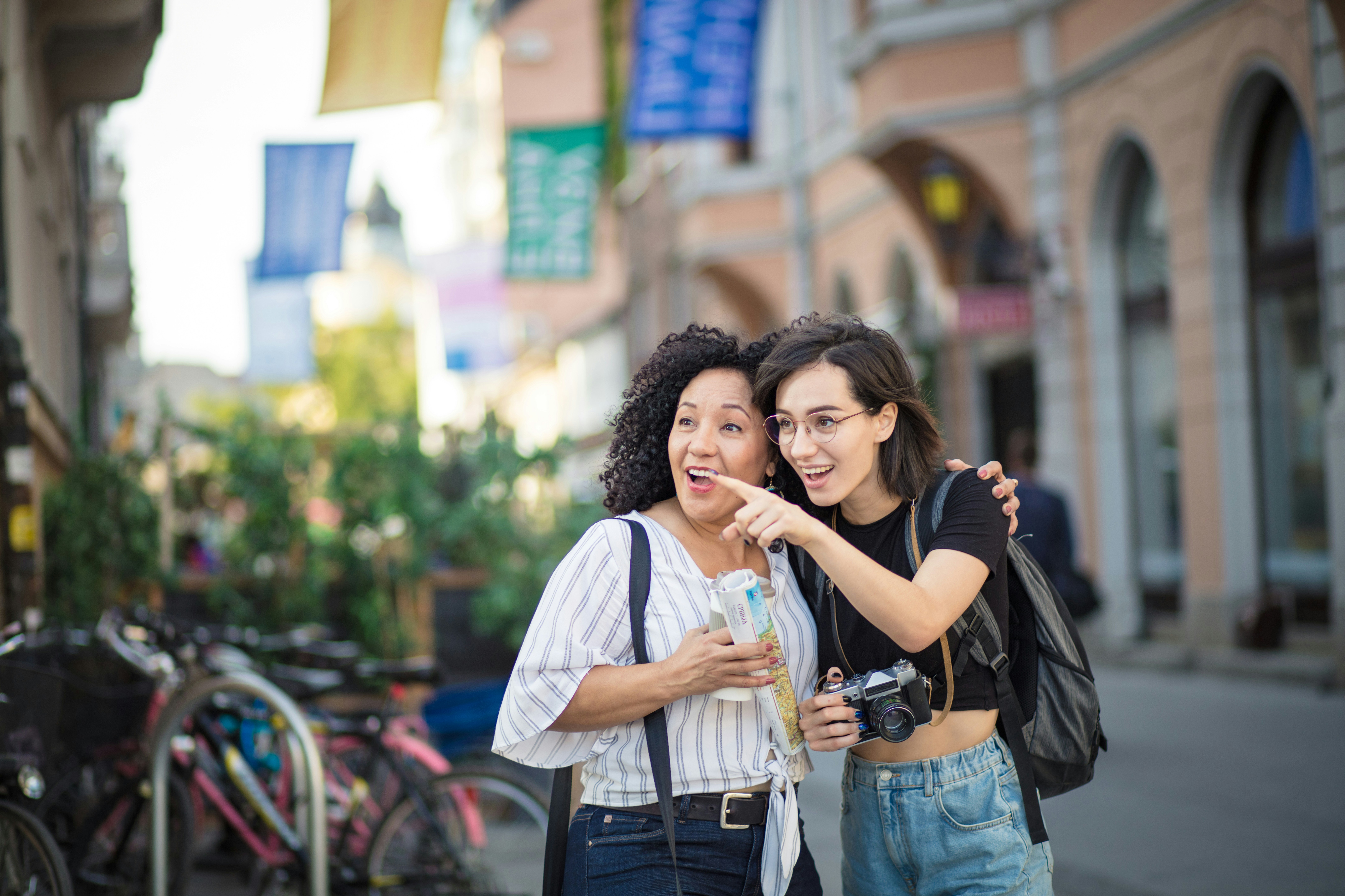 Hinh - Woman traveler with map and a photographer